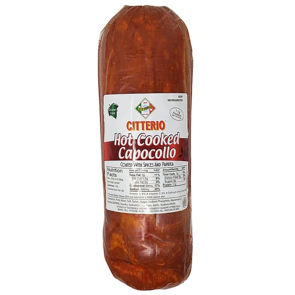 A large chub of Citterio Hot Cooked Capocollo, coated with spices and paprika, with a nutrition label.