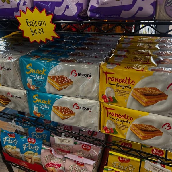 Shelves filled with packaged Italian snack cakes and wafers, including Balconi and Lago brands.