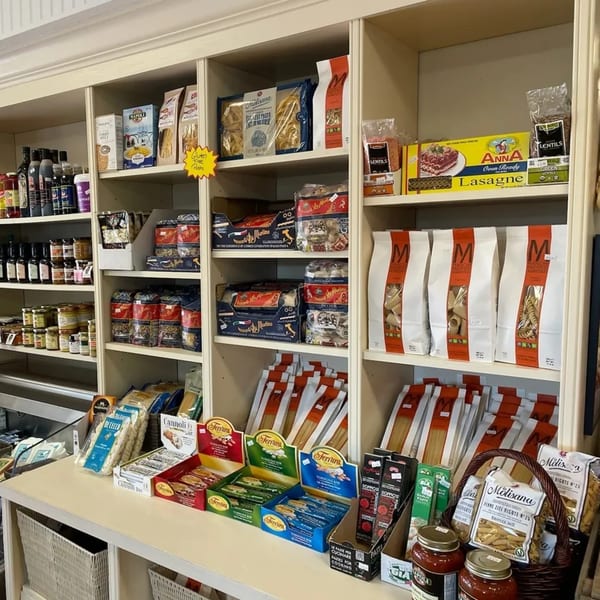 Shelves at Rocco's Market & Deli filled with various Italian pasta, sauces, and deli products.