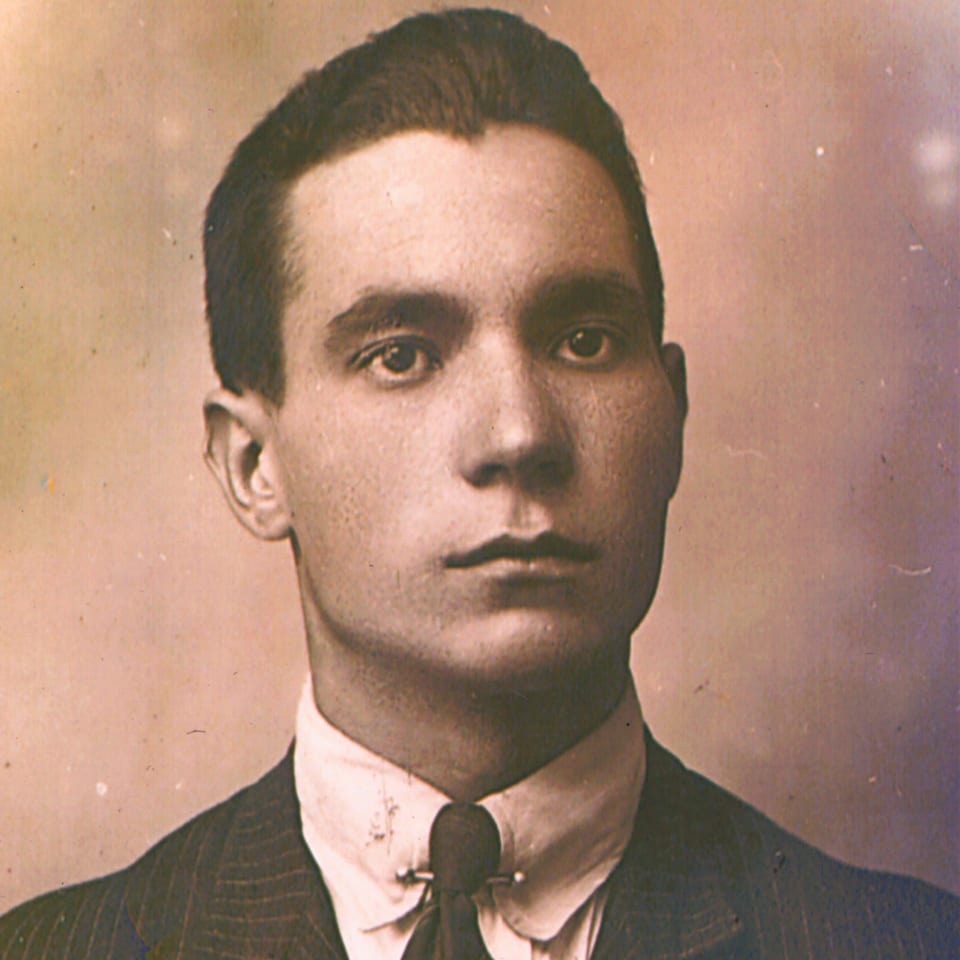 Vintage portrait of a young man in a suit and tie, likely Rocco, the deli's founder.
